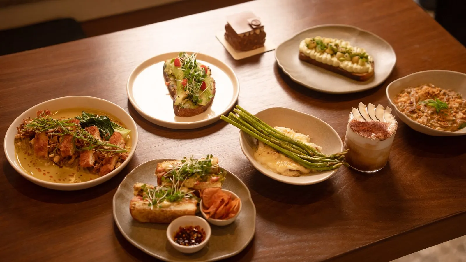 A spread of Vanilla Miel dishes on a wooden table