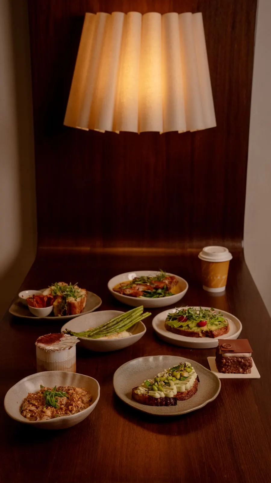 Plates set on a lamp-lit table at Vanilla Miel